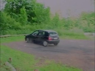 Young couple in a car and in nature